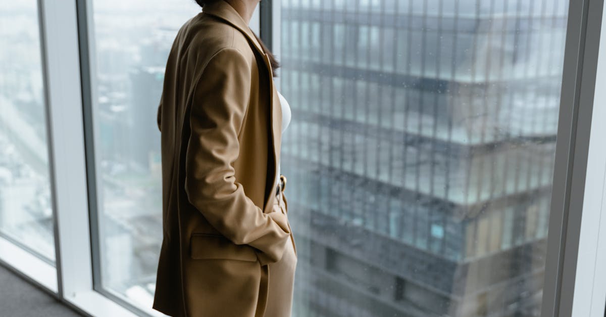 successful professional woman contemplating in modern Hyderabad office, city skyline background, thoughtful expression