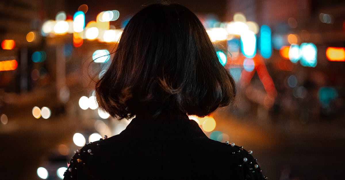 Professional divorced woman in Hyderabad, Banjara Hills, looking thoughtfully at city lights