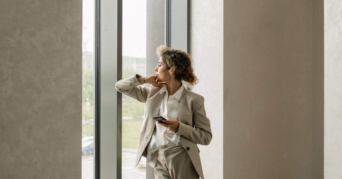 successful woman looking out window Hyderabad