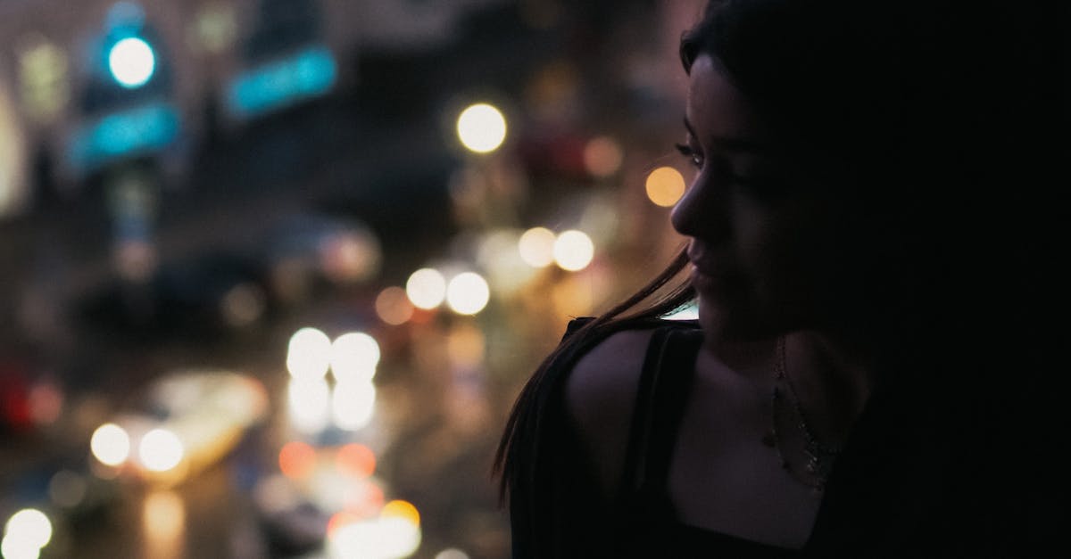 successful woman looking out window Hyderabad night