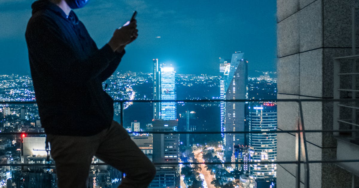 corporate leader looking at Hyderabad city lights at night from balcony