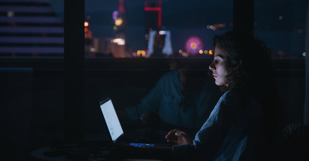 professional woman working laptop night window