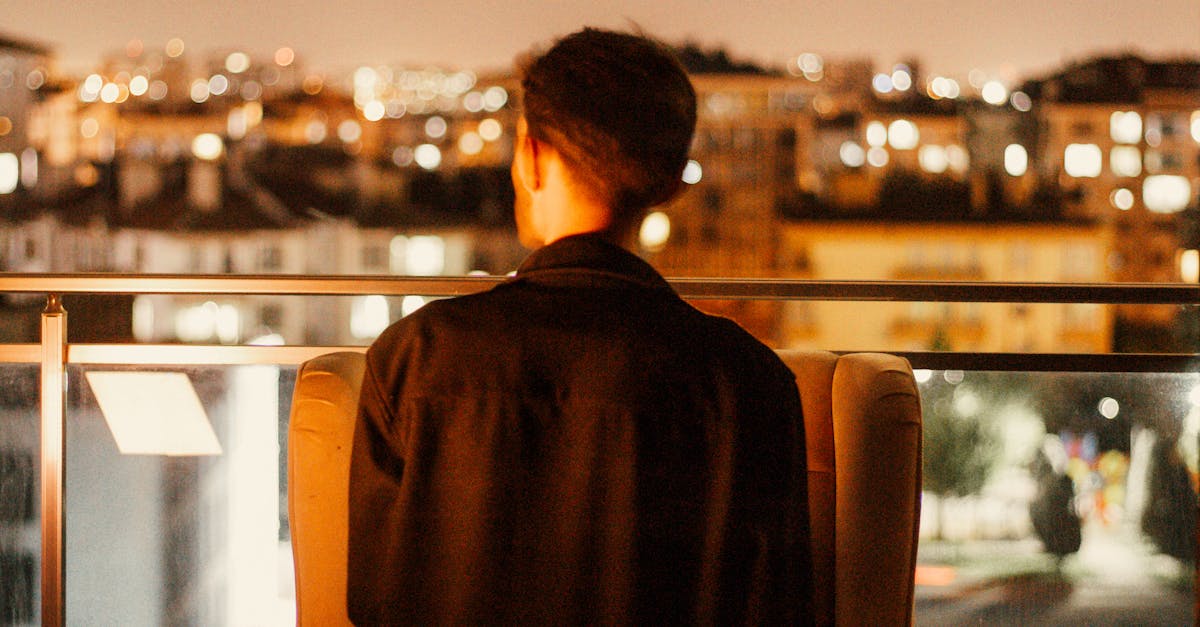 woman sitting alone balcony evening