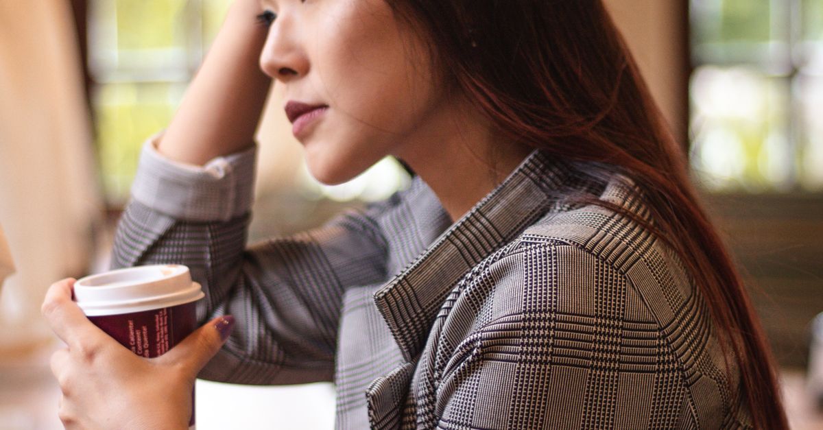 professional woman sitting alone coffee shop