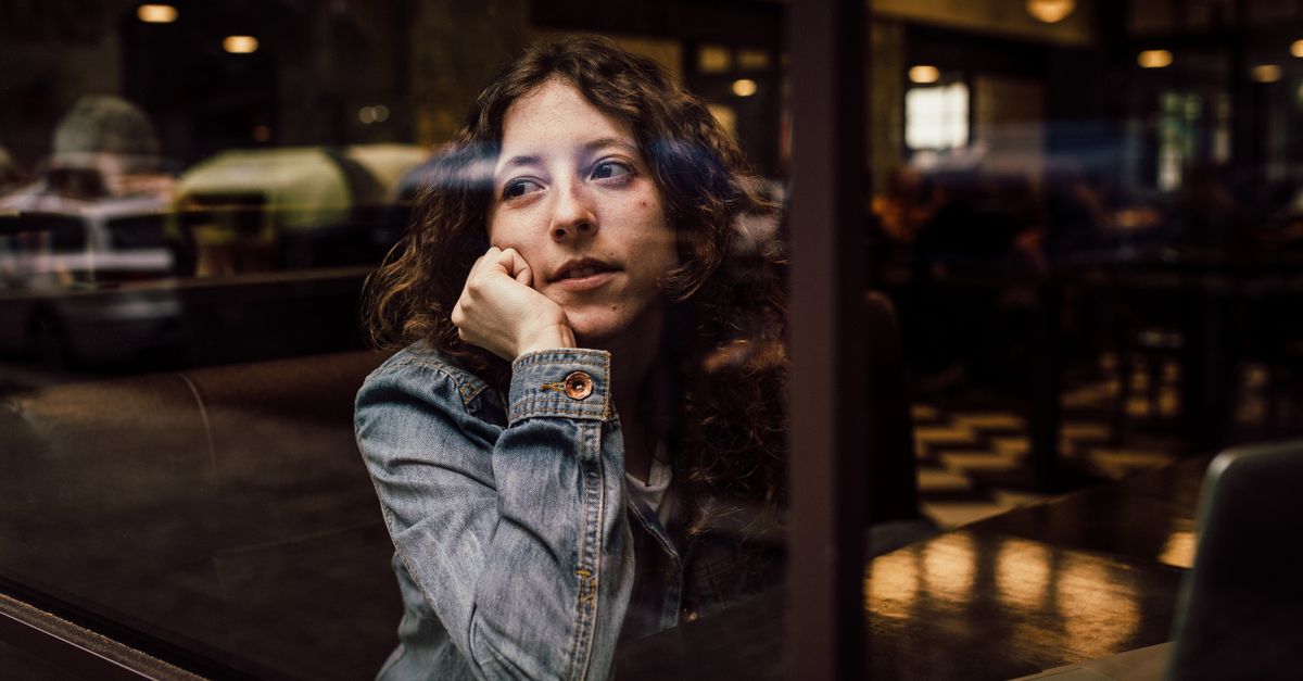 reflective woman café