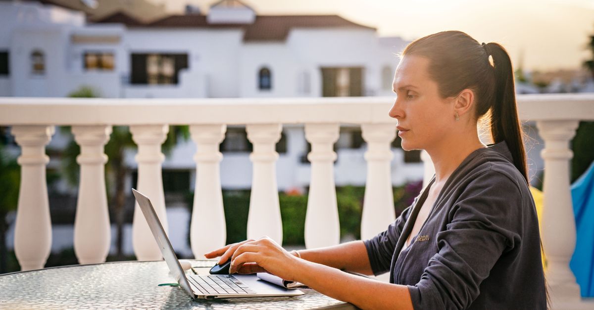 professional woman laptop balcony