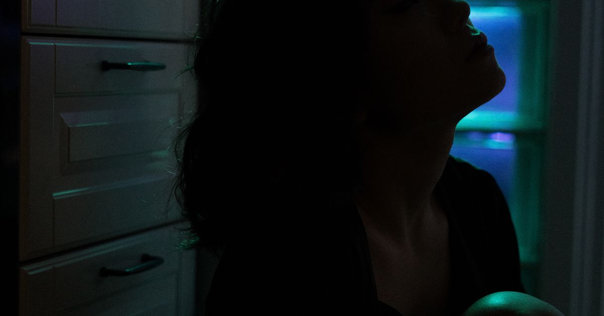 professional woman alone apartment night